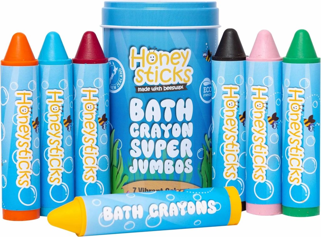 A set of Honeysticks bath crayons in various colors, including red, blue, green, yellow, pink, and orange, displayed in a blue container labeled 'Bath Crayon Super Jumbos'.