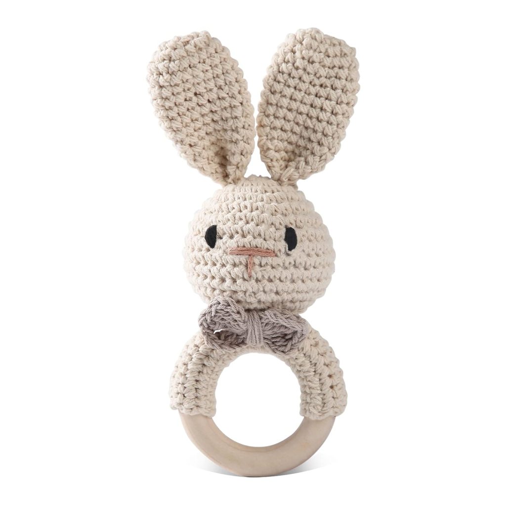 A soft, crocheted bunny toy with long ears and a wooden ring for babies to grasp.