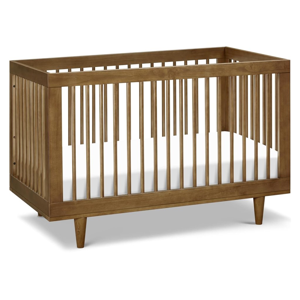 Wooden baby crib with slatted sides and tapered legs, featuring a simple and modern design.