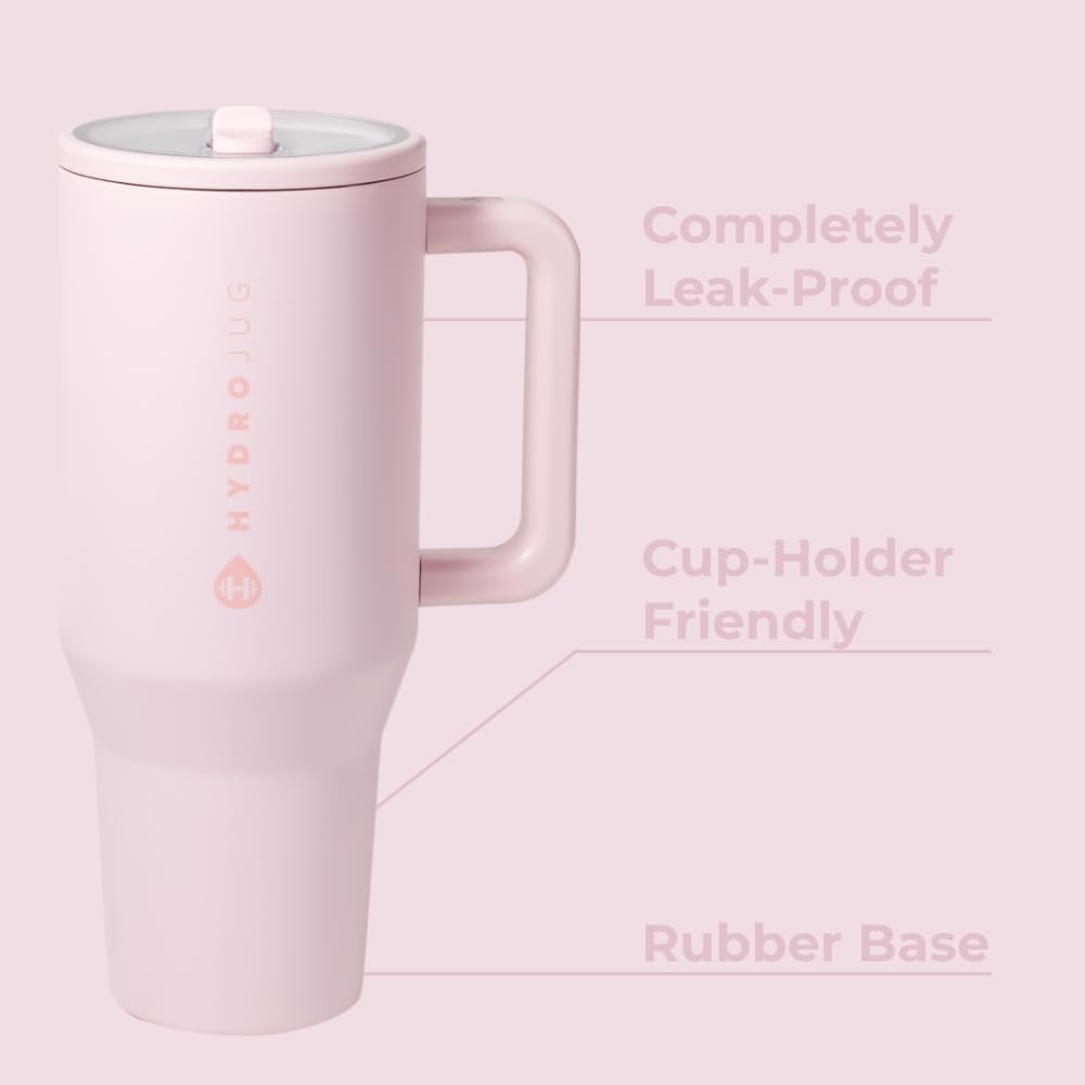 A pink HydroJug water bottle with a lid and handle, featuring labels highlighting its leak-proof design, cup-holder compatibility, and rubber base.