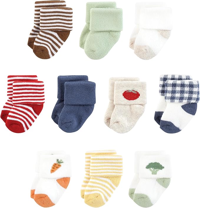 A variety of colorful socks for infants displayed in a grid pattern, featuring stripes, solid colors, and playful designs including a tomato, carrot, and broccoli.
