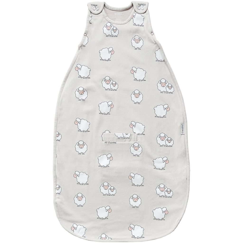 A light-colored baby sleep sack with a pattern of cute sheep illustrations.